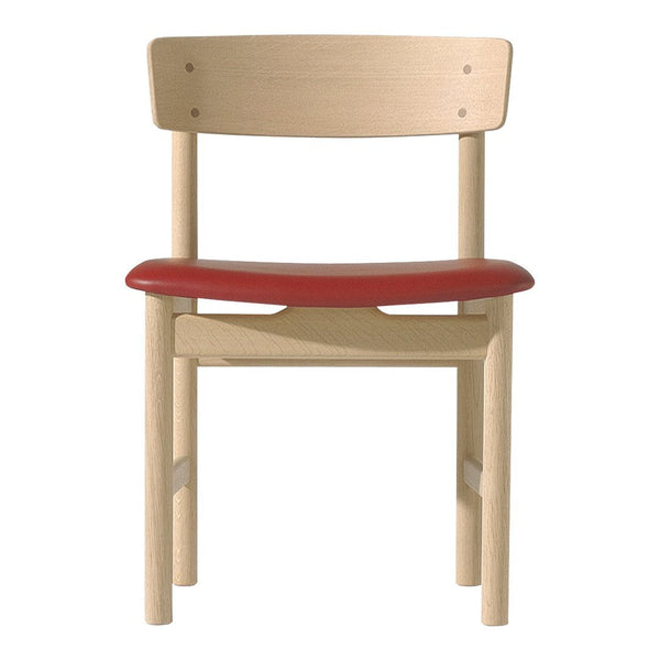 Natural wood chair with a minimalist design featuring a smooth beech finish and a vibrant red seat.