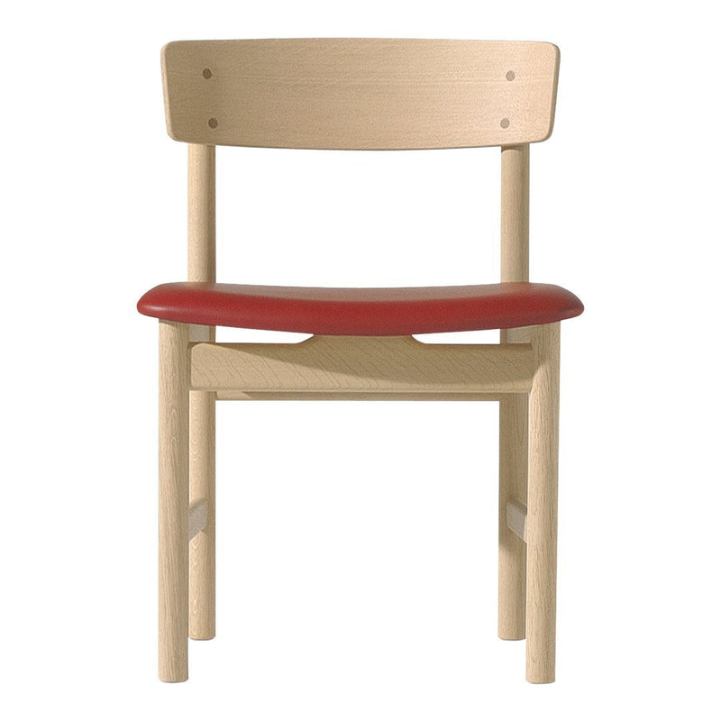 Natural wood chair with a minimalist design featuring a smooth beech finish and a vibrant red seat.