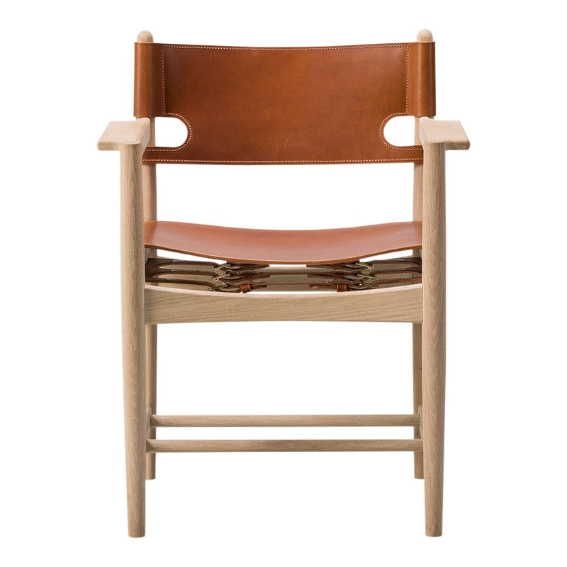 Light wood chair with a warm tan leather seat and backrest, featuring a minimalist design and natural textures.