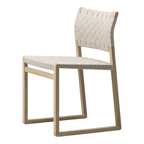 Woven beige dining chair with natural wood frame, featuring a minimalist and modern design.