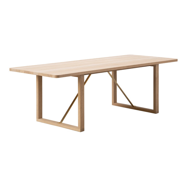 Light natural wood dining table with a smooth, minimalist design and geometric metal legs. Perfect for modern decor.