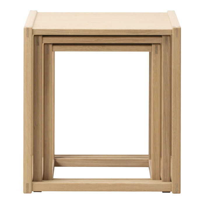 Light oak nesting tables with a smooth, minimalist design and natural wood grain patterns. Perfect for any decor.