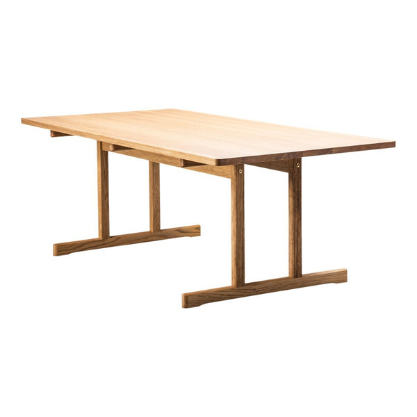 Natural wood dining table with a light oak top and dark walnut legs, featuring a smooth, minimalistic design.