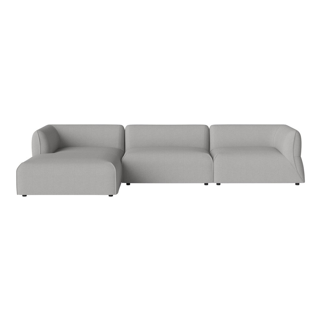 Gray sectional sofa in a minimalist design with smooth, solid fabric and clean lines. Perfect for modern decor.