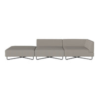 Contemporary gray sectional sofa with clean lines and a smooth texture, featuring sleek metal legs.