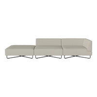 Modern beige sectional sofa with sleek lines and minimalistic style, featuring a smooth fabric and contrasting metal legs.