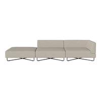 Light beige fabric sofa with a minimalist design and sleek black metal legs, featuring a solid color pattern.