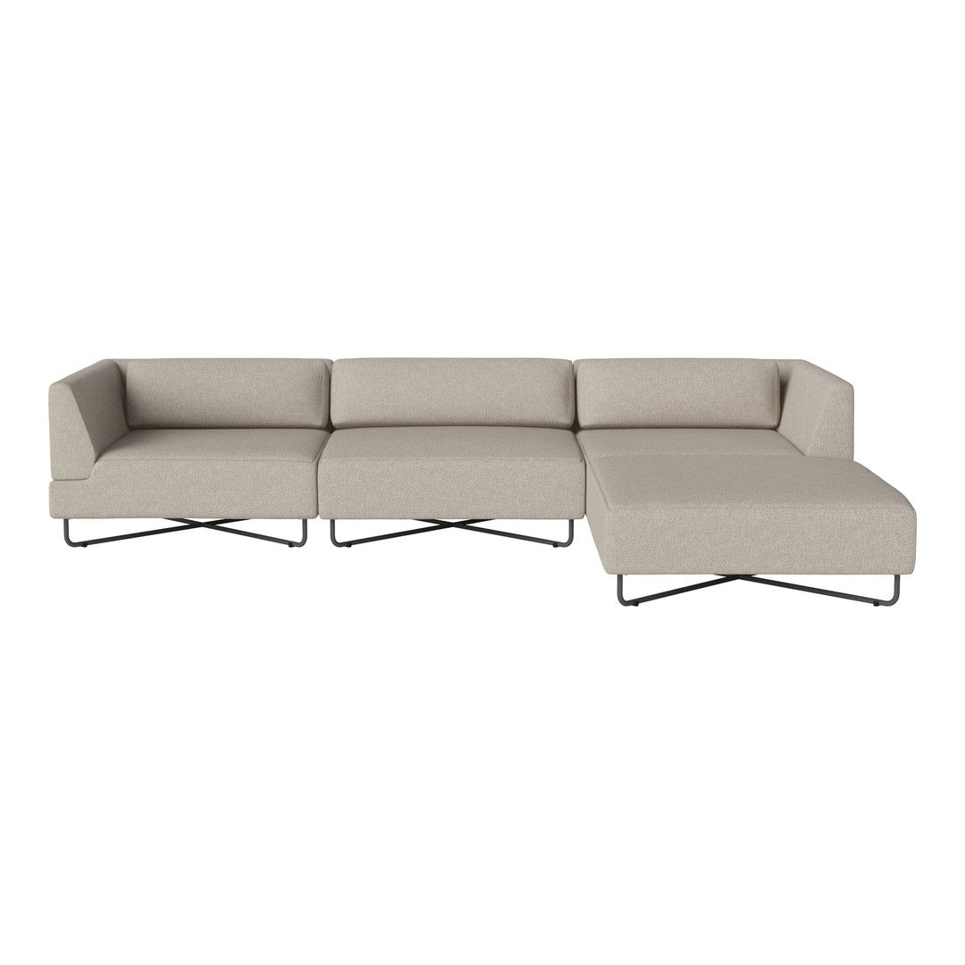 Beige sectional sofa with a minimalist design and smooth fabric texture, featuring sleek black metal legs.
