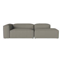 Modern sectional sofa in soft grey fabric, featuring clean lines and minimalist design. Ideal for contemporary spaces.