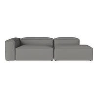 "Elegant gray sectional sofa with a modern, minimalist design and smooth, solid fabric upholstery."