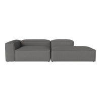 Modern gray sectional sofa with a sleek, minimalistic design and soft fabric upholstery.