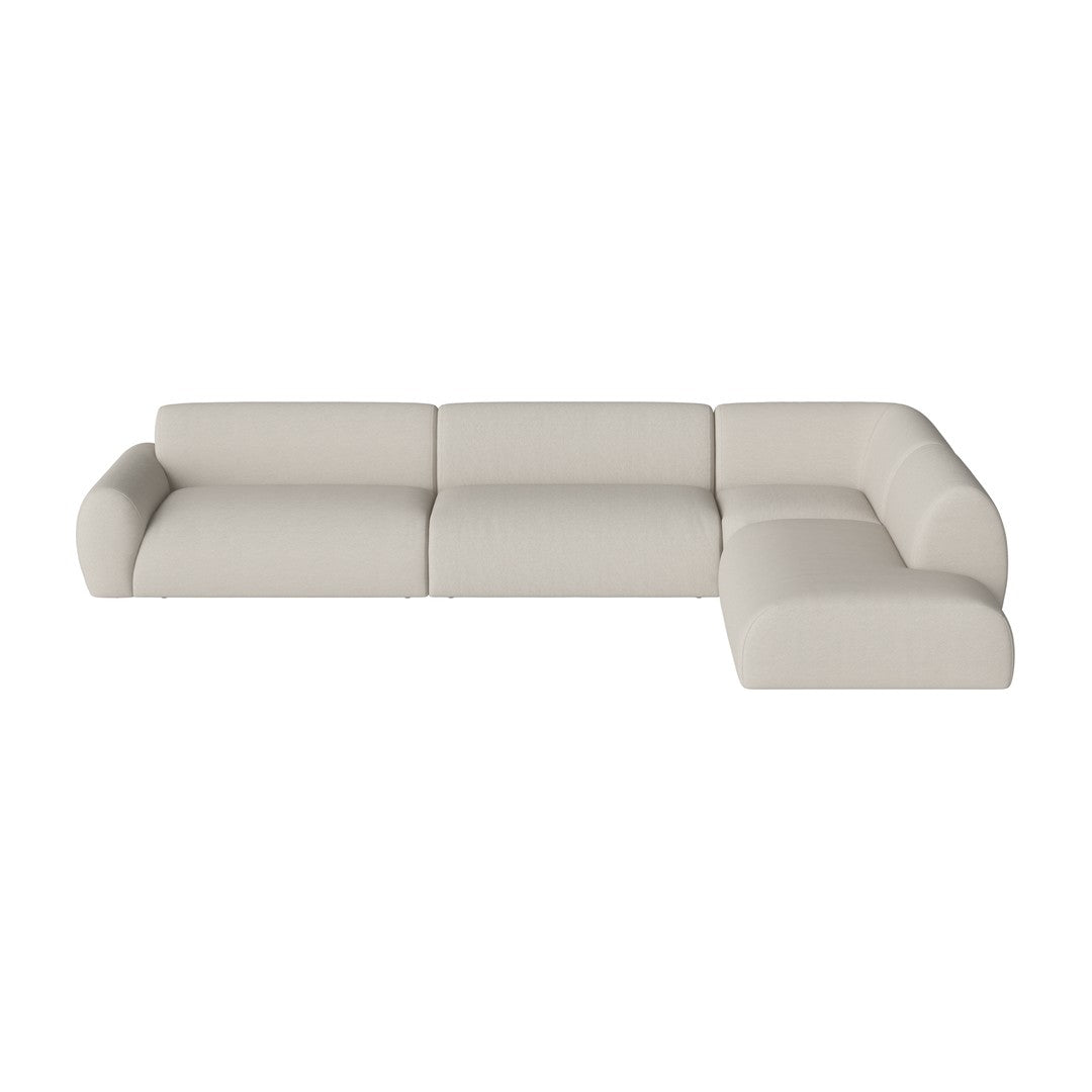 Modern L-shaped sofa in soft beige upholstery with sleek, minimalistic design and smooth, curved edges.