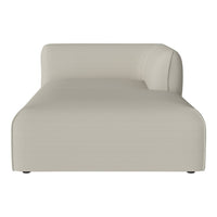 Modern beige chaise lounge with a sleek, minimalist design and smooth fabric texture. Ideal for contemporary interiors.