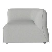 Curved light gray sofa section with a minimalist design and subtle texture for modern decor.