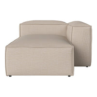 Beige textured fabric chaise lounge with modern, minimalist design and soft, curved edges. Ideal for cozy spaces.