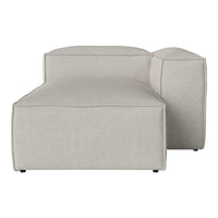 Light gray chaise lounge with a smooth, textured fabric and minimalist design. Hexagonal shape with clean lines.