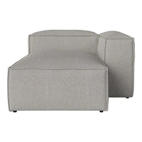 Light gray fabric chaise lounge with a simple textured pattern, featuring clean lines and a modern design.