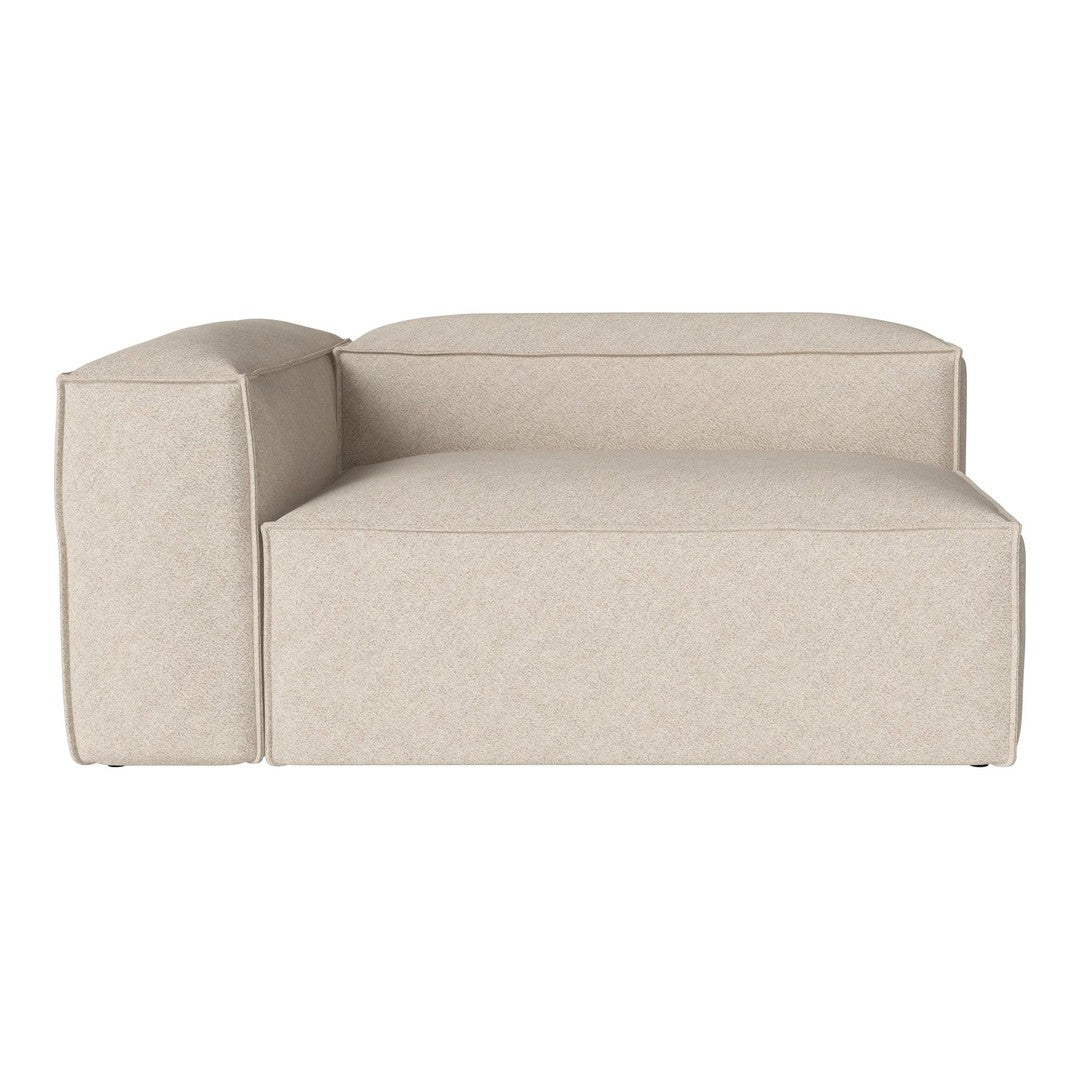 Beige upholstered chaise lounge with a smooth, textured fabric and minimalist design. Ideal for modern decor.
