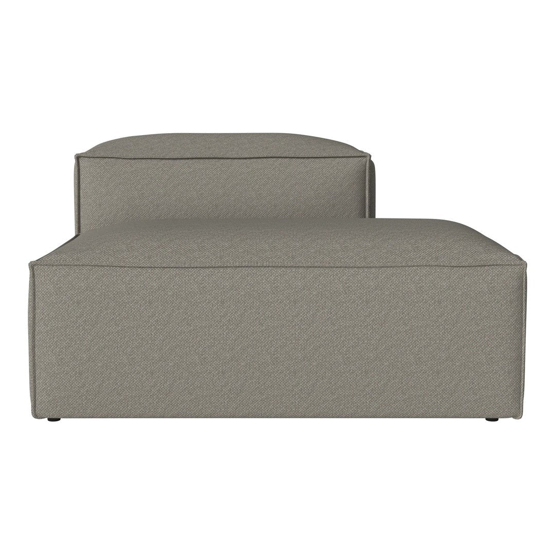 Sleek, modern chaise lounge in soft taupe fabric with subtle textured pattern, perfect for contemporary decor.