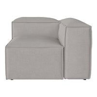 Gray upholstered sectional sofa with a minimalist design and smooth texture, perfect for modern decor.