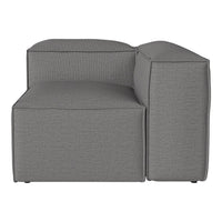 Gray upholstered corner sofa with a sleek, minimalist design and textured fabric pattern. Modern and stylish accent piece.