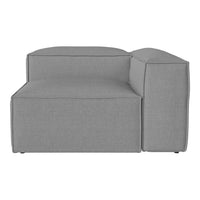 Gray upholstered sectional sofa with a clean, modern design and smooth textured pattern.