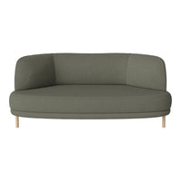 Green upholstered sofa with a modern curved design and light wooden legs, creating a sleek and stylish look.