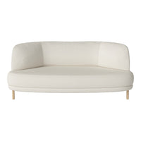 White curved sofa with smooth upholstery and light wood legs, offering a minimalist and modern aesthetic.