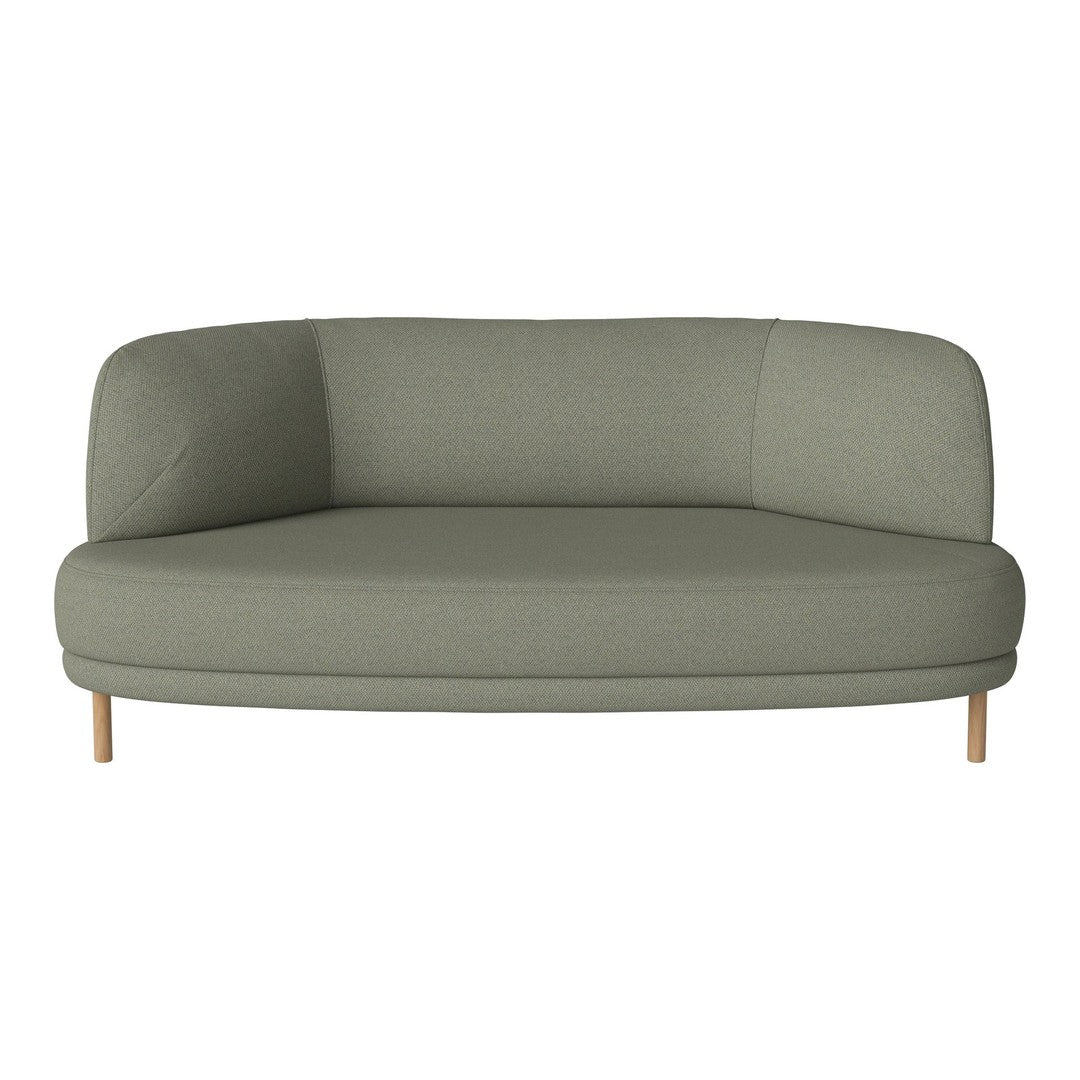 Soft green upholstered couch with a minimalist design and light wooden legs, featuring a smooth, rounded shape.