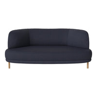 Navy blue curved sofa with minimalist design, featuring smooth upholstery and light wood legs. Perfect for modern decor.