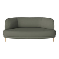 Olive green curved sofa with a smooth fabric texture and light wooden legs, perfect for modern living spaces.