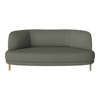 Green upholstered sofa with a smooth, minimalistic design and natural wood legs. Modern aesthetic for any space.
