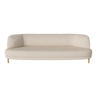Light beige curved sofa with a smooth fabric texture and wooden legs, perfect for modern interiors.
