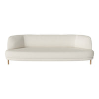 Cream-colored curved sofa with smooth, minimalist design and light wooden legs. Perfect for modern interiors.