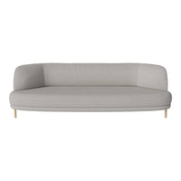 Light grey curved sofa with smooth fabric and wooden legs, perfect for modern living spaces.