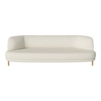 Cream-colored curved sofa with smooth fabric and natural wood legs, ideal for modern minimalist decor.