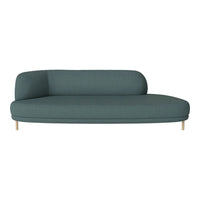 Teal curved couch with a smooth, textured fabric and minimalist design, perfect for modern living spaces.