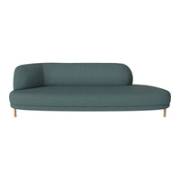 Teal curved sofa with a textured pattern and natural wood legs, perfect for modern living spaces.