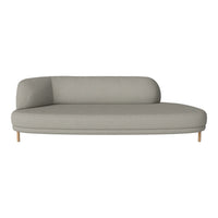 Light gray curved sofa with smooth fabric and wooden legs, perfect for modern interiors. Minimalistic and stylish design.