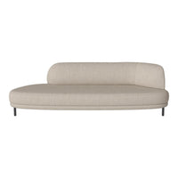 Beige oval sofa with smooth upholstery and minimalist design, featuring a rounded back and sleek metal legs.