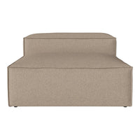 Beige upholstered chaise lounge with a smooth, minimalist design and subtle texture. Perfect for modern decor.