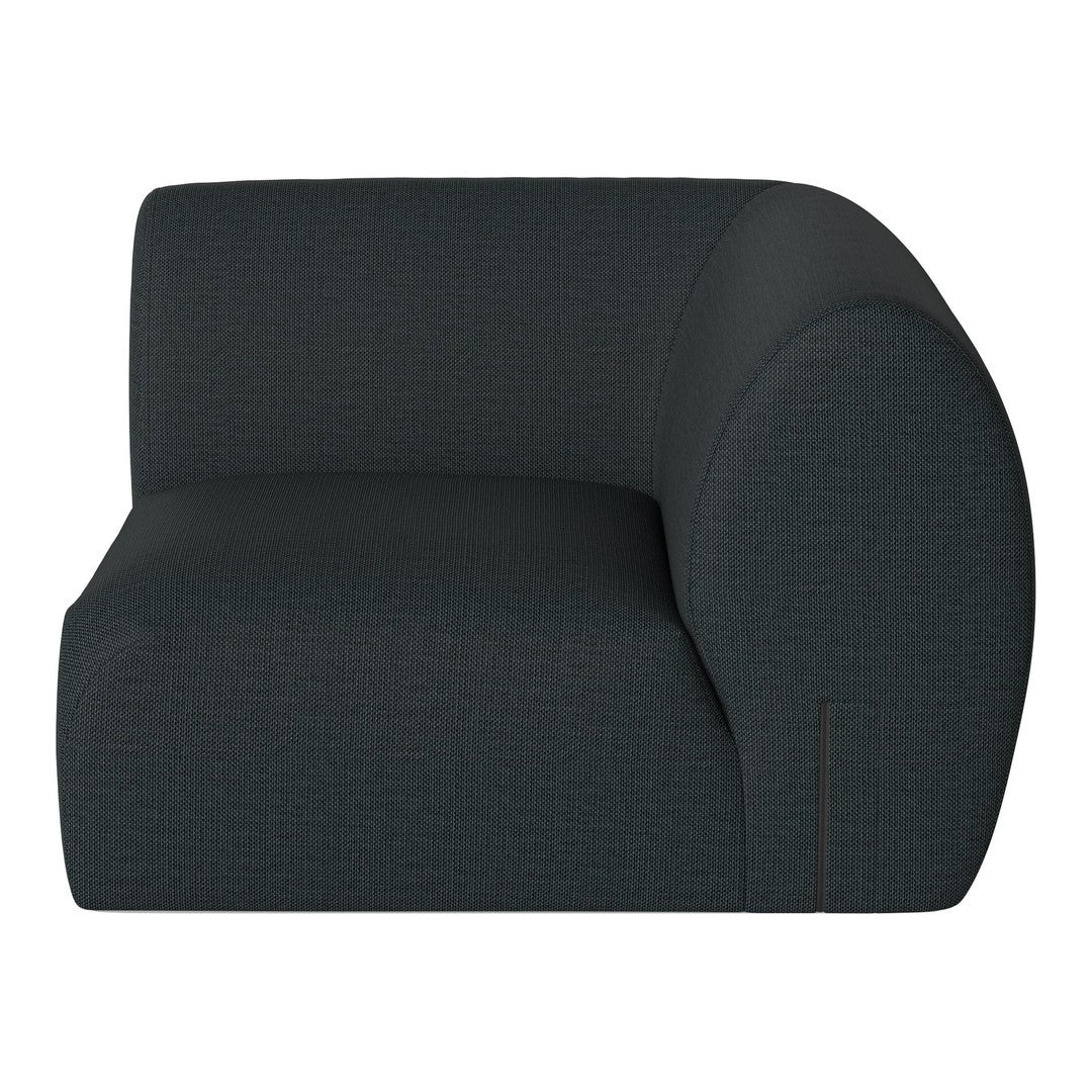 Curved armchair in a textured dark blue fabric with subtle geometric patterning. Ideal for modern interiors.