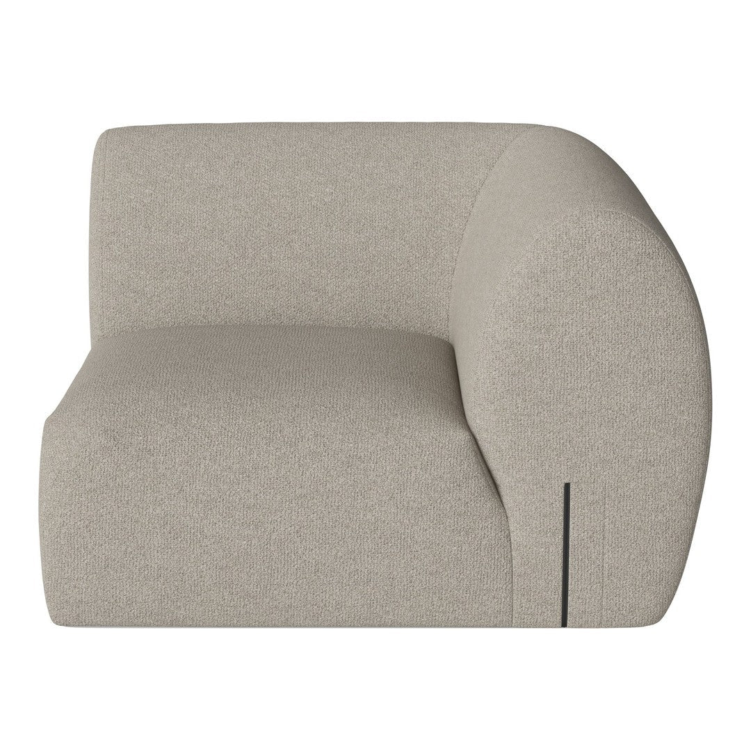 Beige curved armchair with a textured fabric finish and subtle seam detailing, adding a modern touch to any decor.