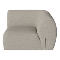 Beige curved armchair with a textured fabric finish and subtle seam detailing, adding a modern touch to any decor.