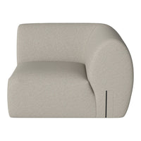 Light beige curved armchair with a smooth texture and minimalist design, perfect for modern decor.
