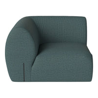 Teal curved sofa with textured fabric, featuring a subtle pattern for modern home decor.