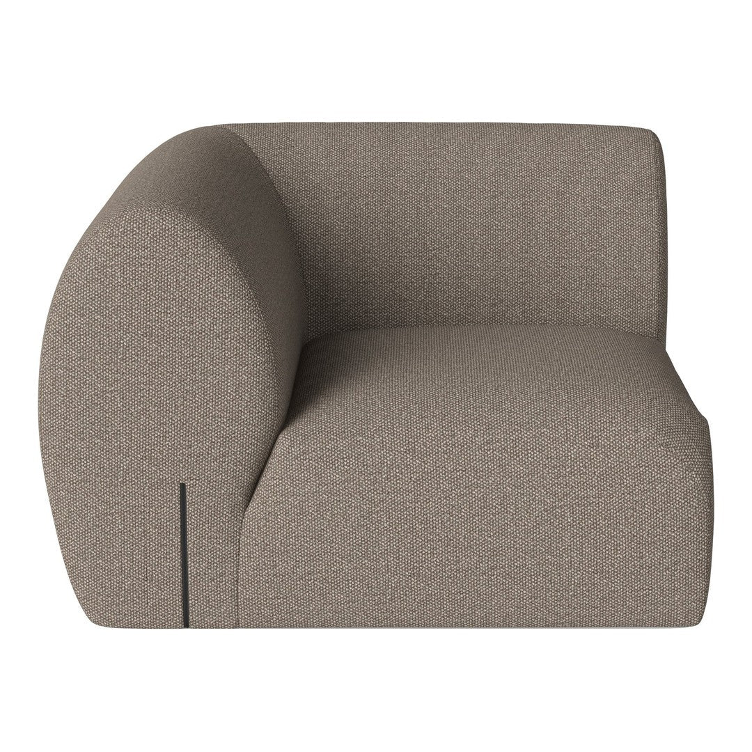 Modern curved armchair in a soft taupe color with a textured fabric pattern. Ideal for contemporary decor.