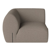 Modern curved armchair in a soft taupe color with a textured fabric pattern. Ideal for contemporary decor.