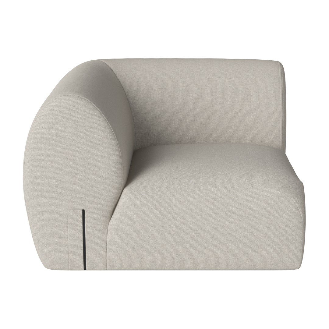 Beige upholstered sofa with a smooth, minimalist design and rounded shapes. Ideal for modern living spaces.