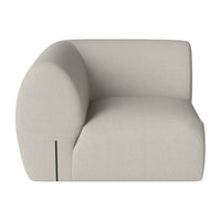 Beige upholstered sofa with a smooth, minimalist design and rounded shapes. Ideal for modern living spaces.